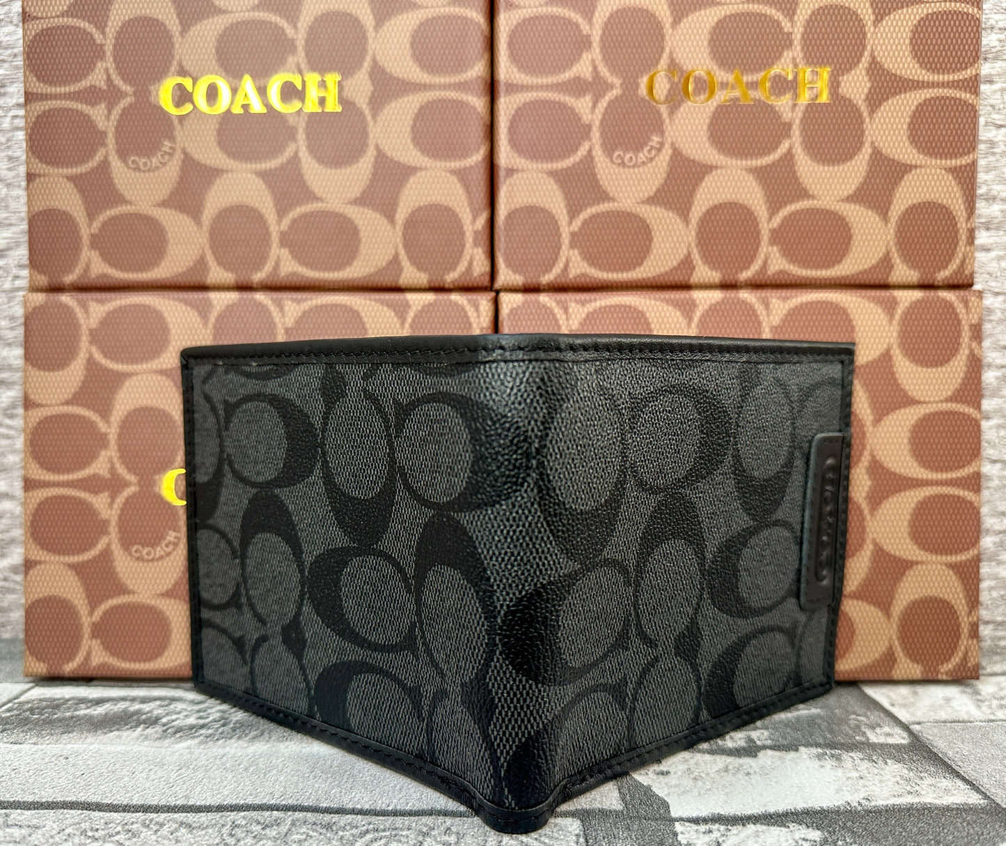 Cartera negra C0ach con monograma